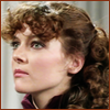 Nyssa with her hair pulled back looking left.