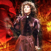 Nyssa in fairy dress from knees upward, elaborate red background.