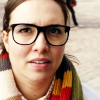 Osgood from Doctor Who, looking up, wearing a fourth Doctor scarf.