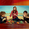 Amy, River and Rory having a picnic from The Impossible Astronaut.  Widescreen image with a red background to make it square