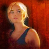 Ruby head and shoulders in a sleeveless top.  Red background.