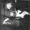 Sara crouching with gun