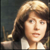 Sarah with short hair and a brown jacket.