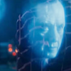The Shalka Doctor.  Image of floating face of Richard E. Grant from Rogue.  Face is in blue tones to suggest a computer image.