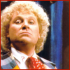 The Sixth Doctor with bigger hair looking superior