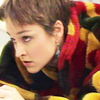 Tegan in a fleecy patterned top.  Leaning on her arms looking up and annoyed.