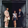 Tegan, Turlough and the Fifth Doctor standing in a doorway