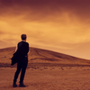 Silhouette of the twelfth Doctor against an orange landscape of sand and sky.