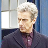 The twelfth doctor.  Head and shoulders in front of the Tardis looking to one side.