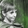 Vicki from Doctor Who looking skeptical.  Greenish background.