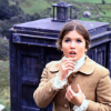 Victoria, in colour, standing outside the TARDIS.