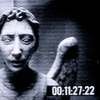 A weeping angel on a grainy camera image with a time stamp.
