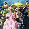 Cinderella in a pink dress standing in front of the carriage facing the fairy godmother (in black)