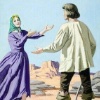 Woman in plan purple dress and green headscarf greets blind man in wilderness.