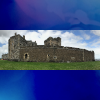 Panorama of Blackness Castle from its grounds.  Blue background top and bottom.