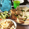 Cucumber sandwiches, cucumber sticks and a bowl of popcorn.