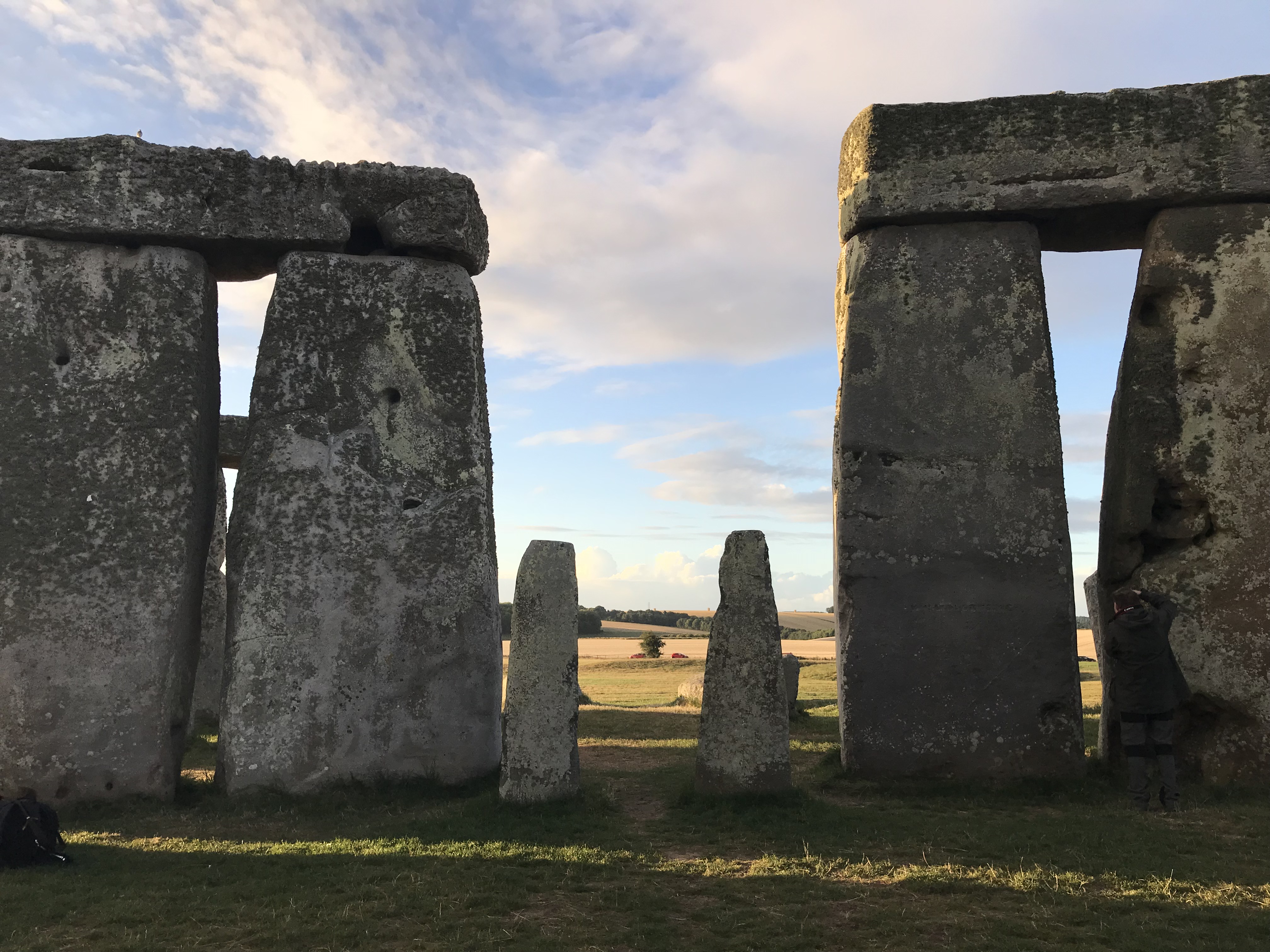View from within Stonehenge out through the entrance - two large pairs of stones with capstones either side and then two smaller upright stones slightly in front of them.