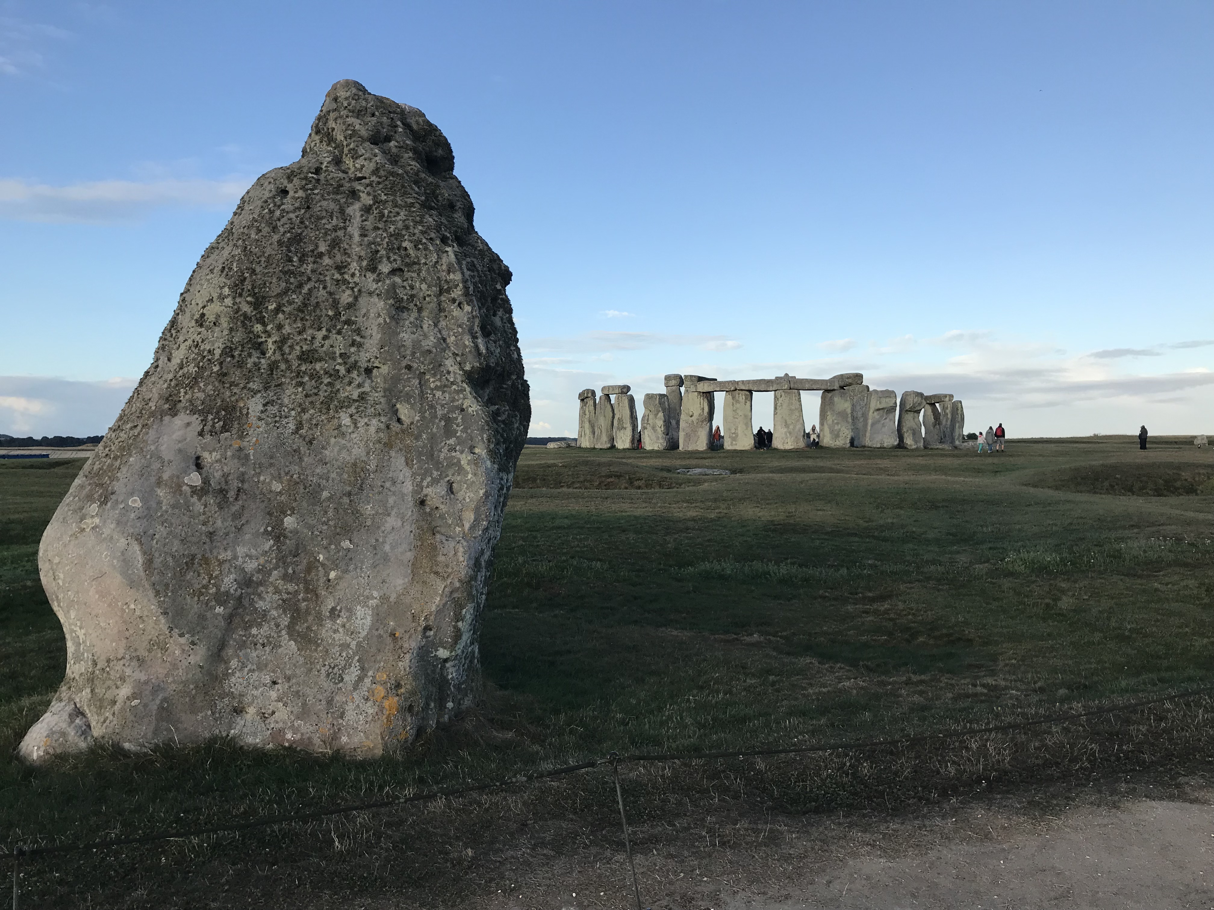 Big standing stone in the foreground. Stonehenge in the background.