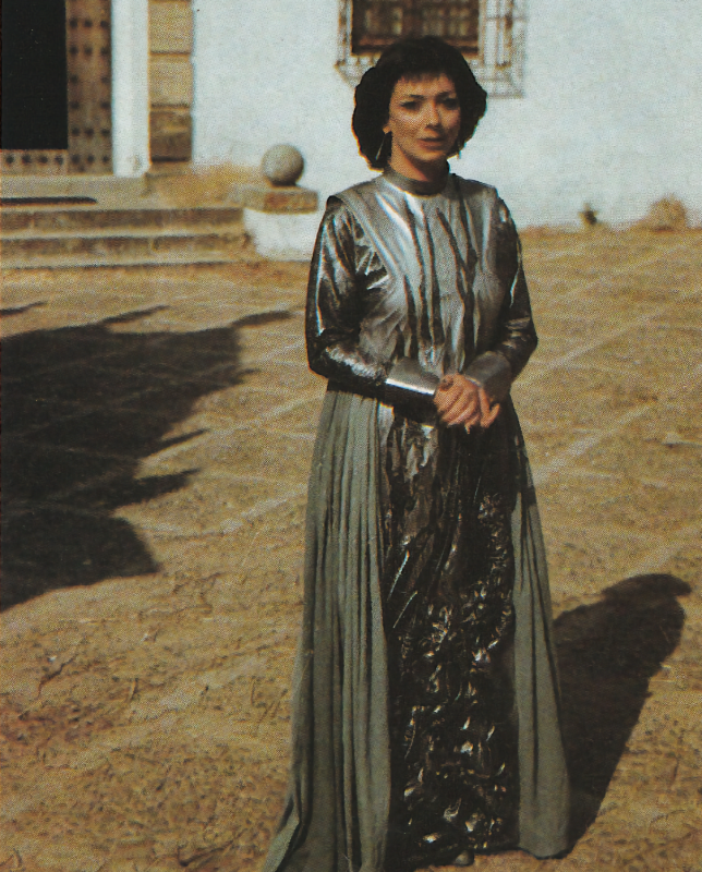 Jacqueline Pearce as Chessene, standing in the courtyard.