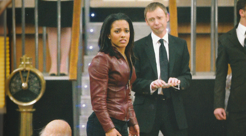 Picture of Martha looking upset from Last of the Time Lords.  The Master can be seen, slightly out of focus behind her, making an exaggerated sad face.