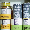 Tins of food in the Village Shop all with the Penny-farthing logo.